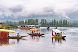 a group of boats floating on top of a lake