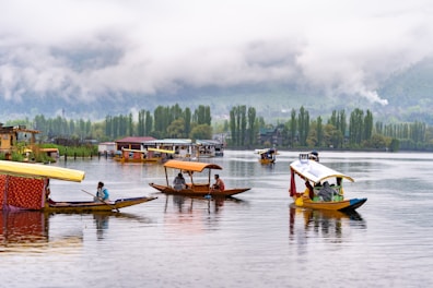 a group of boats floating on top of a lake