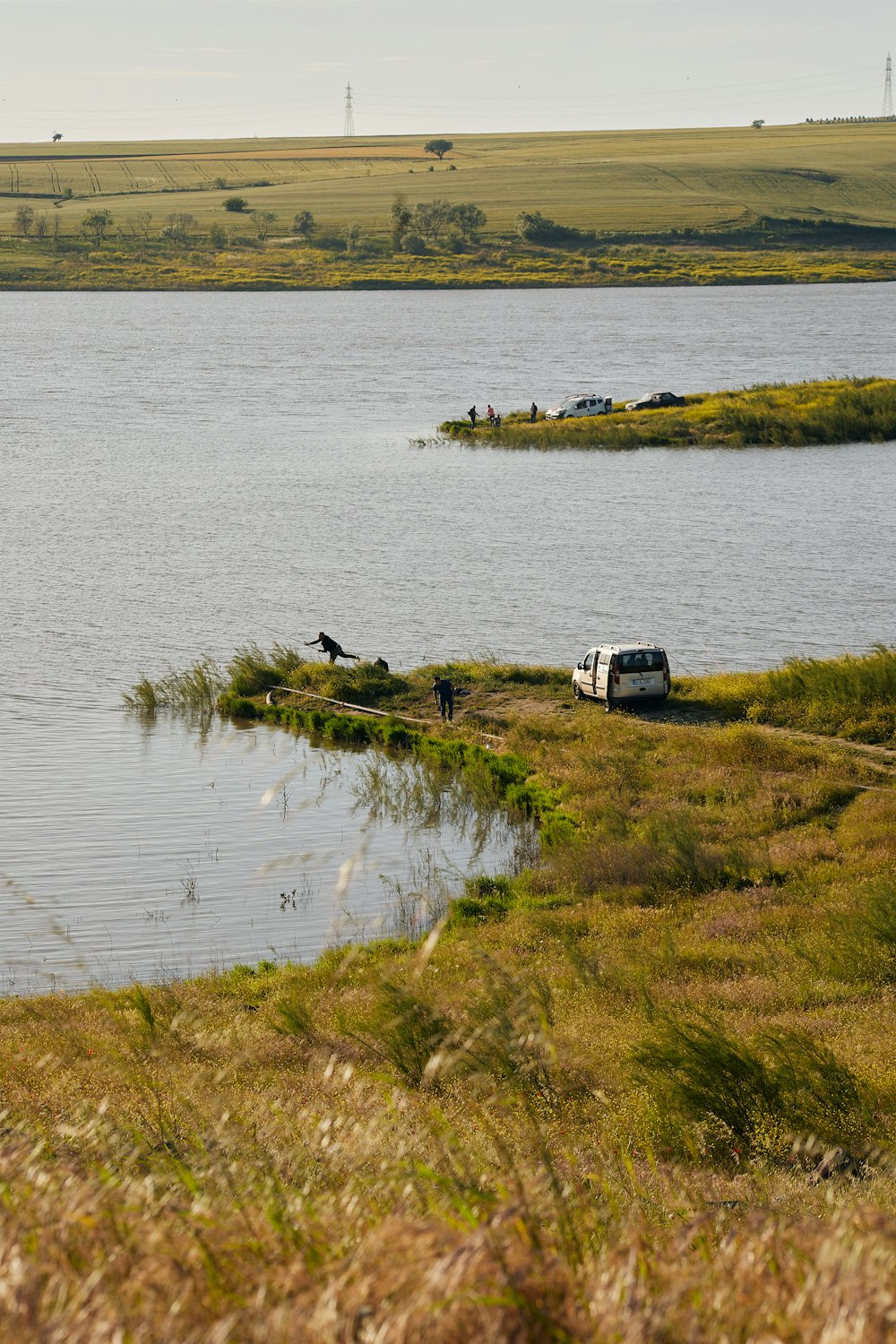 a van is parked on the shore of a lake