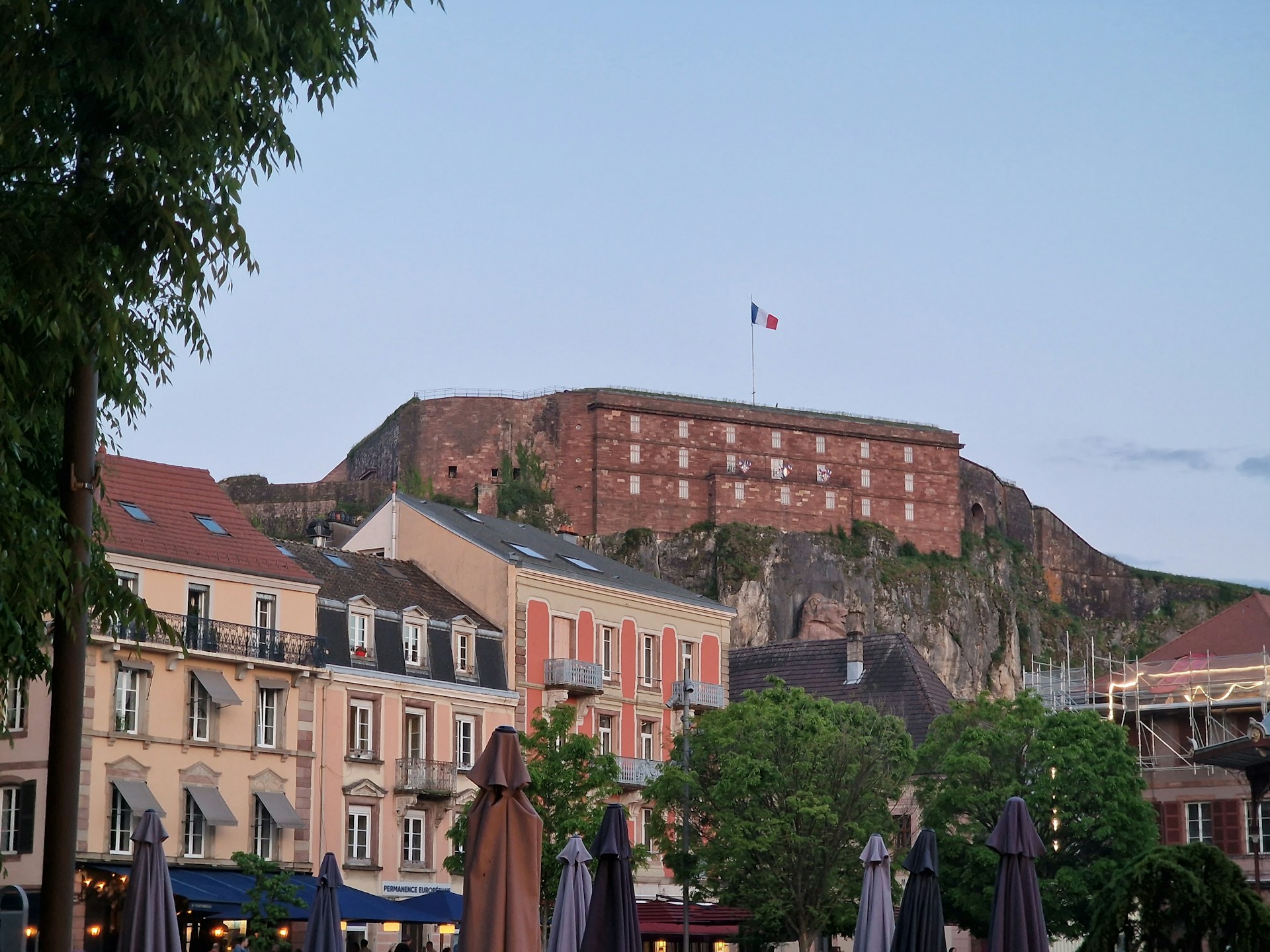 a city with a castle on top of a hill