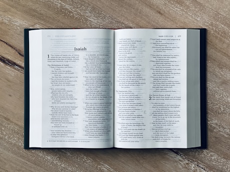 an open book sitting on top of a wooden table