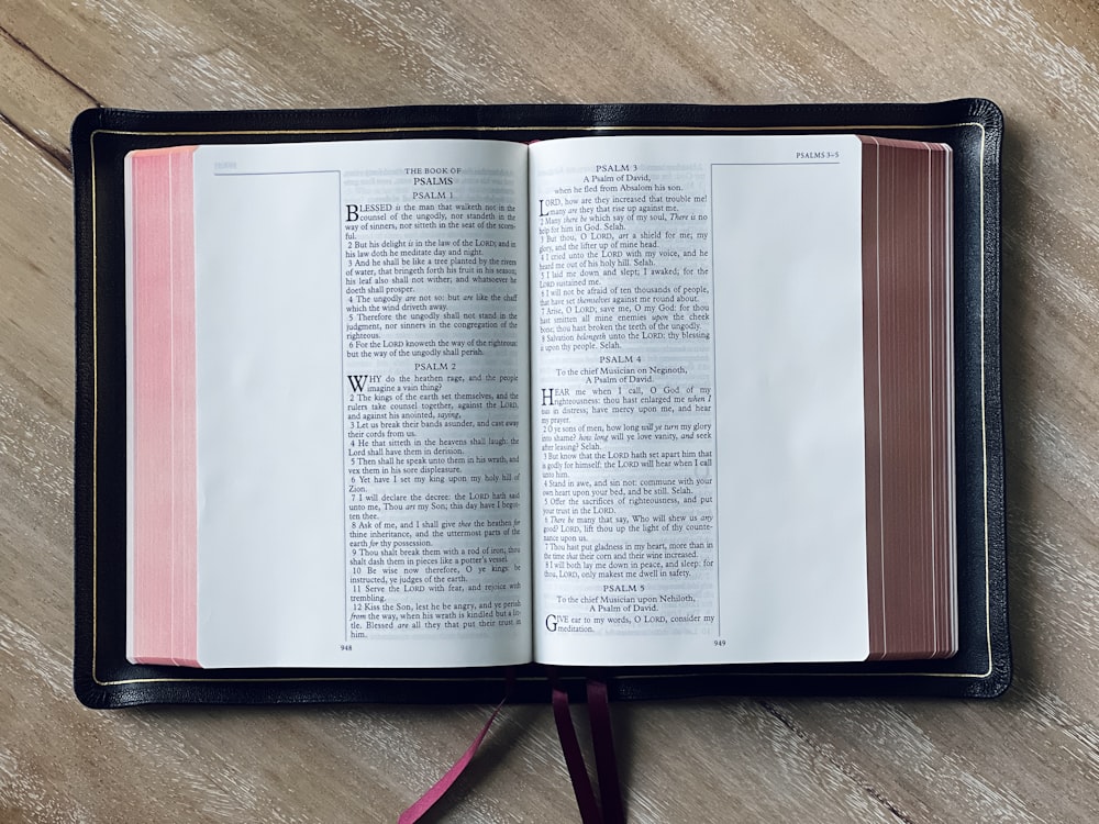 an open book sitting on top of a wooden table