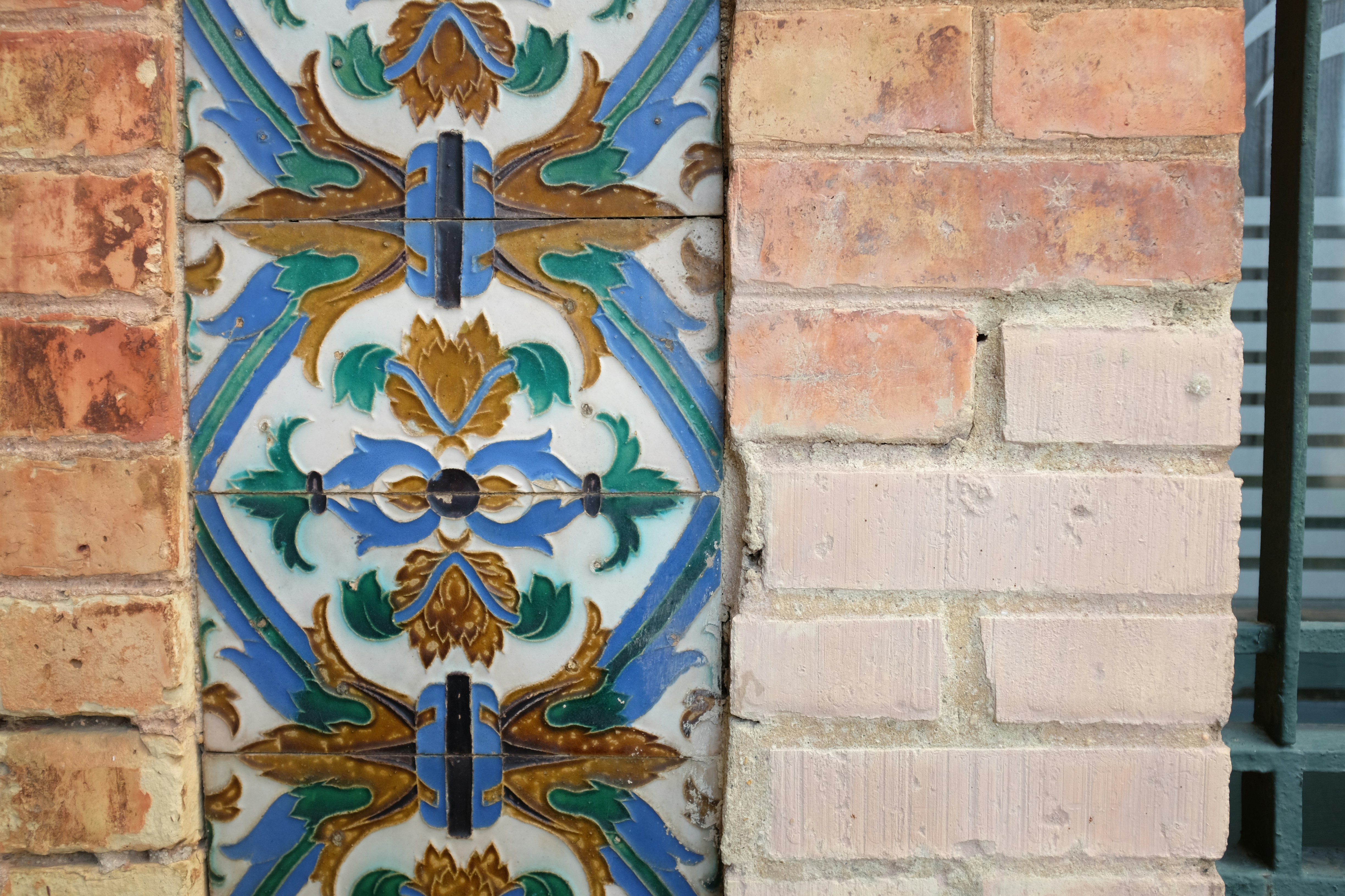 A close up of a decorative tile on a brick wall photo Free Spain