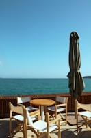 a patio with a table and chairs and an umbrella
