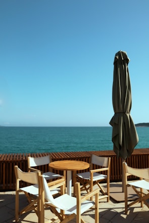 a patio with a table and chairs and an umbrella