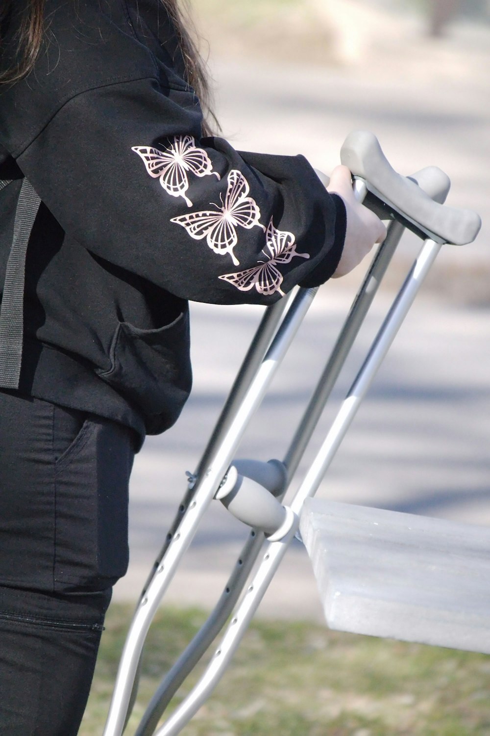 a woman holding a white bench with a butterfly design on it