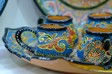 a close up of a plate with cups on it