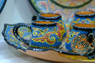a close up of a plate with cups on it