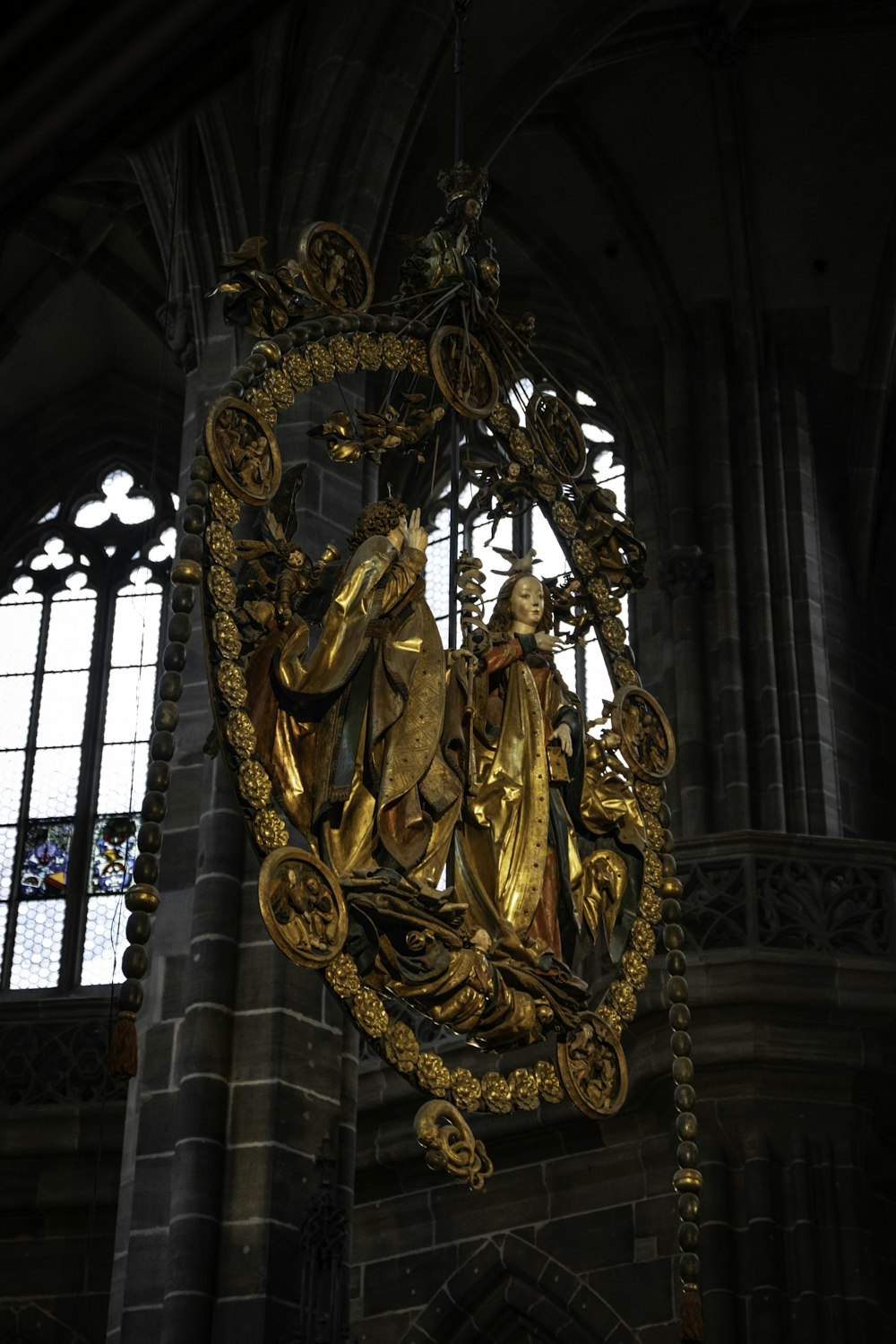 a gold statue of jesus and mary in a cathedral