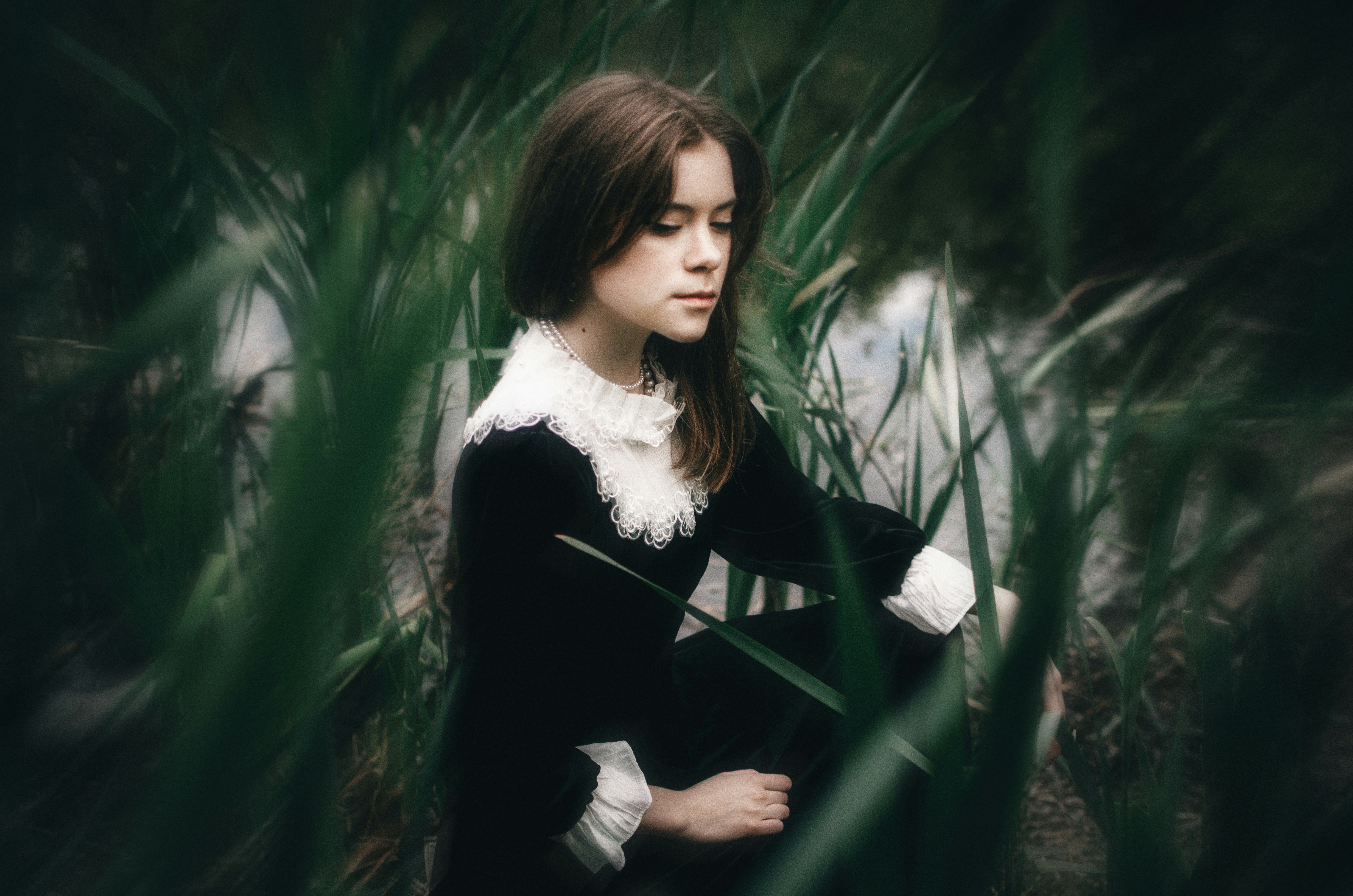 a woman standing in a field of tall grass