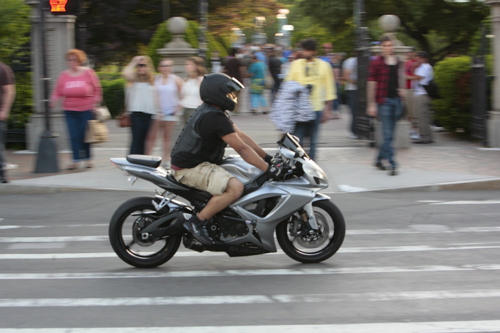 a man riding a motorcycle on a city street