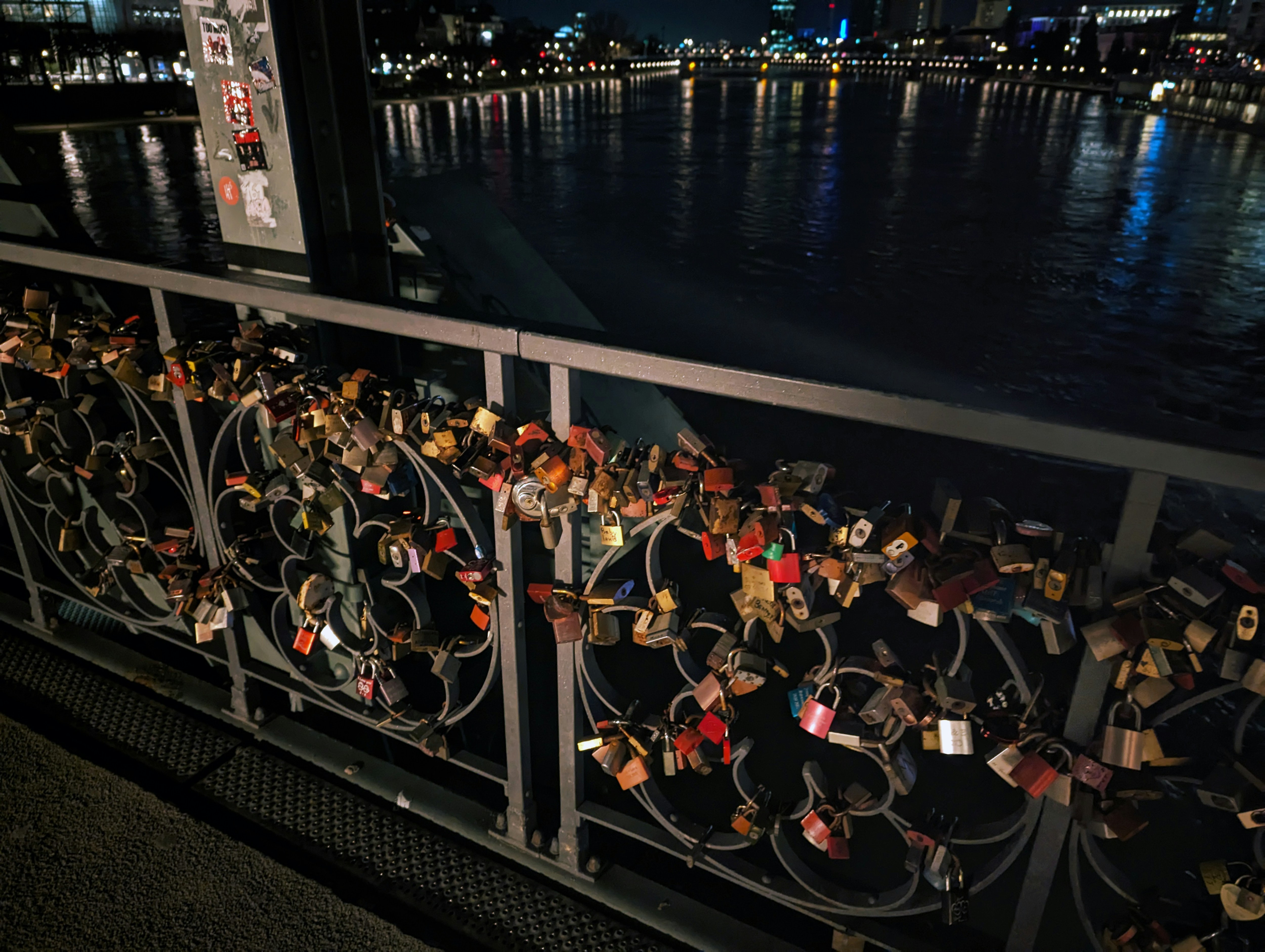 a bunch of padlocks are attached to a fence