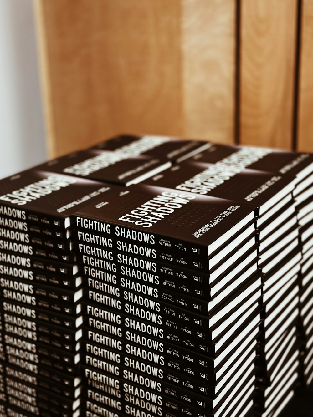 a stack of books sitting on top of a wooden table