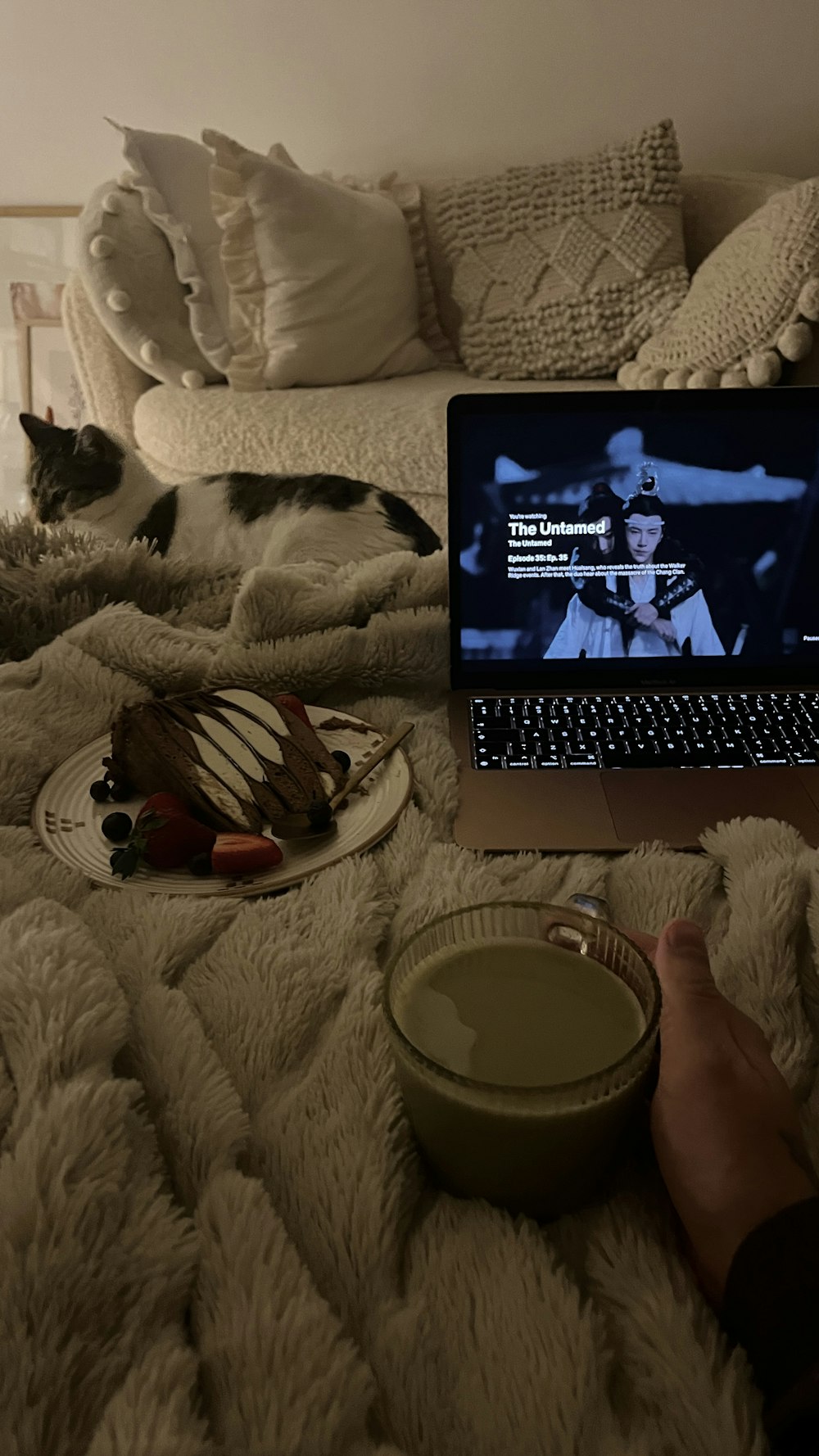 a laptop computer sitting on top of a bed