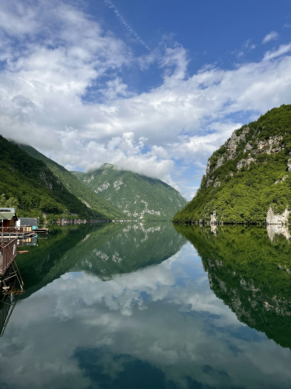 a body of water surrounded by mountains and trees