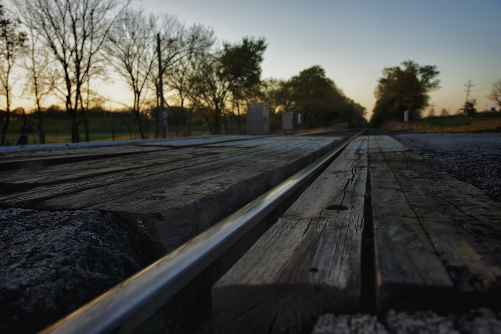 a wooden bench sitting on top of a road