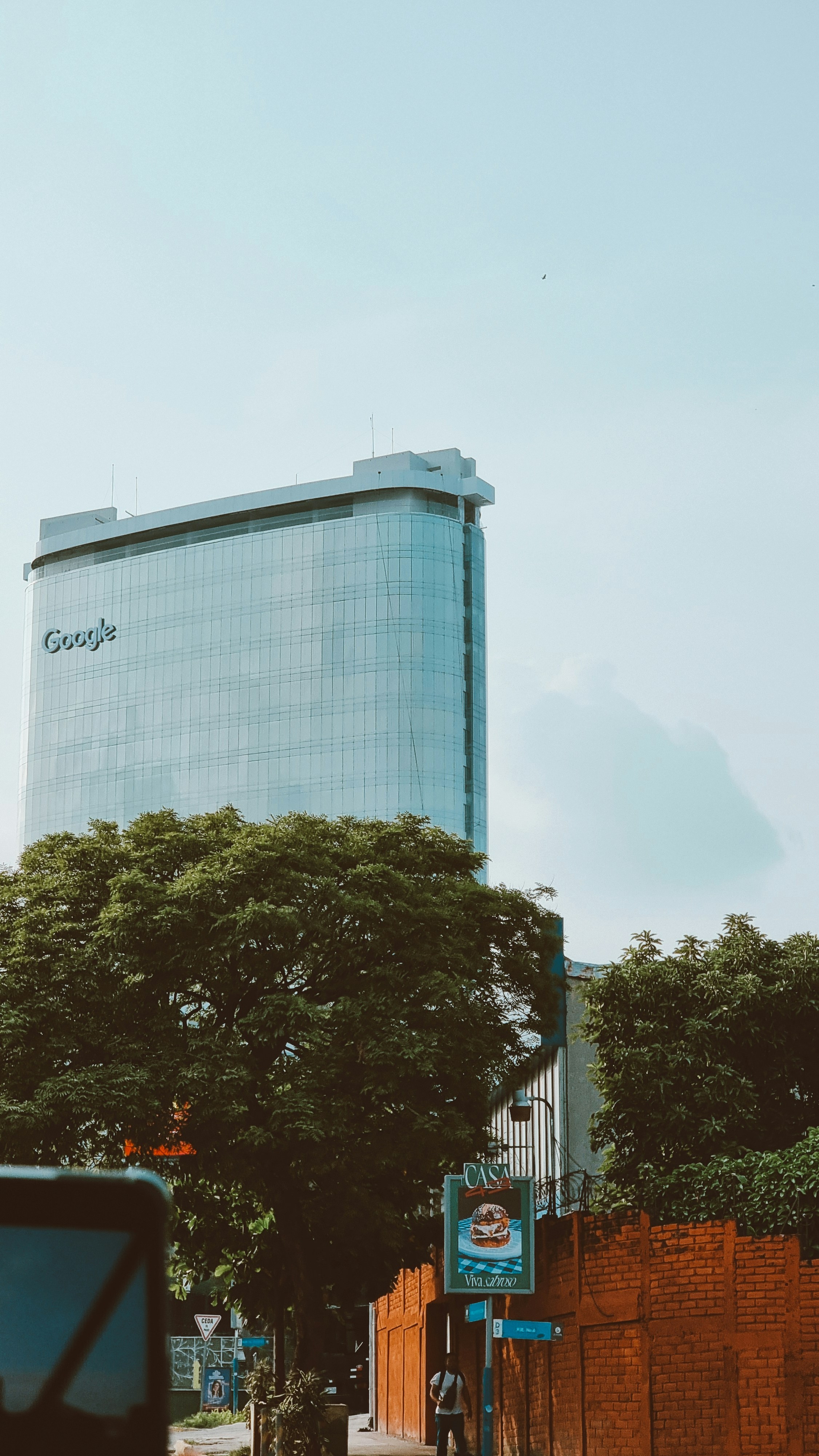 a tall building with a google sign on the side of it