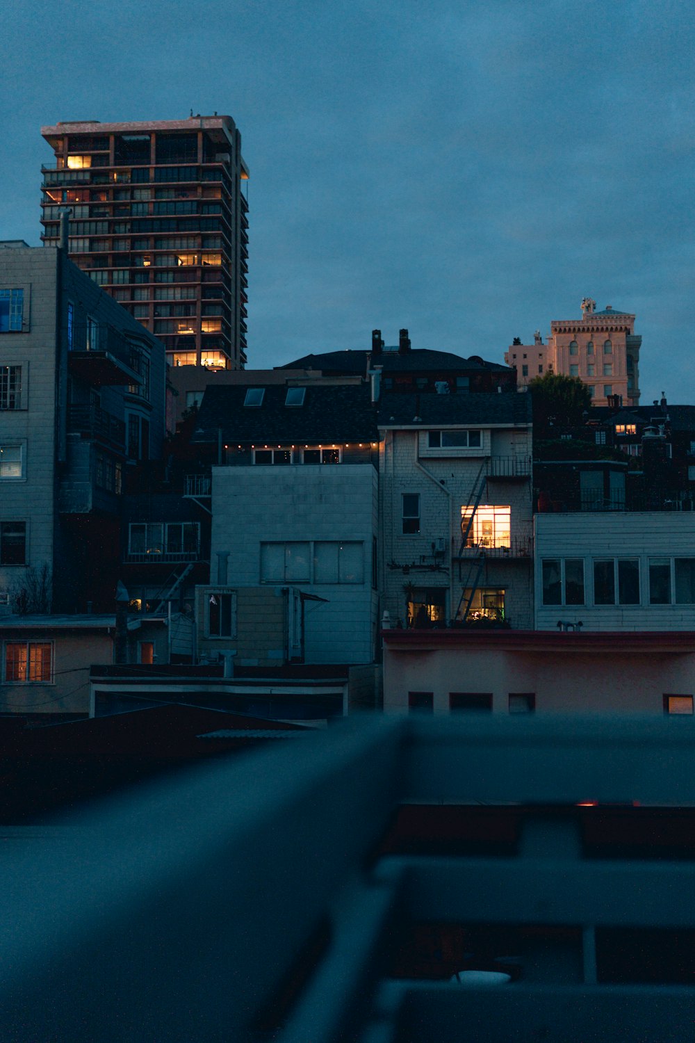 a view of a city at night from the roof of a building