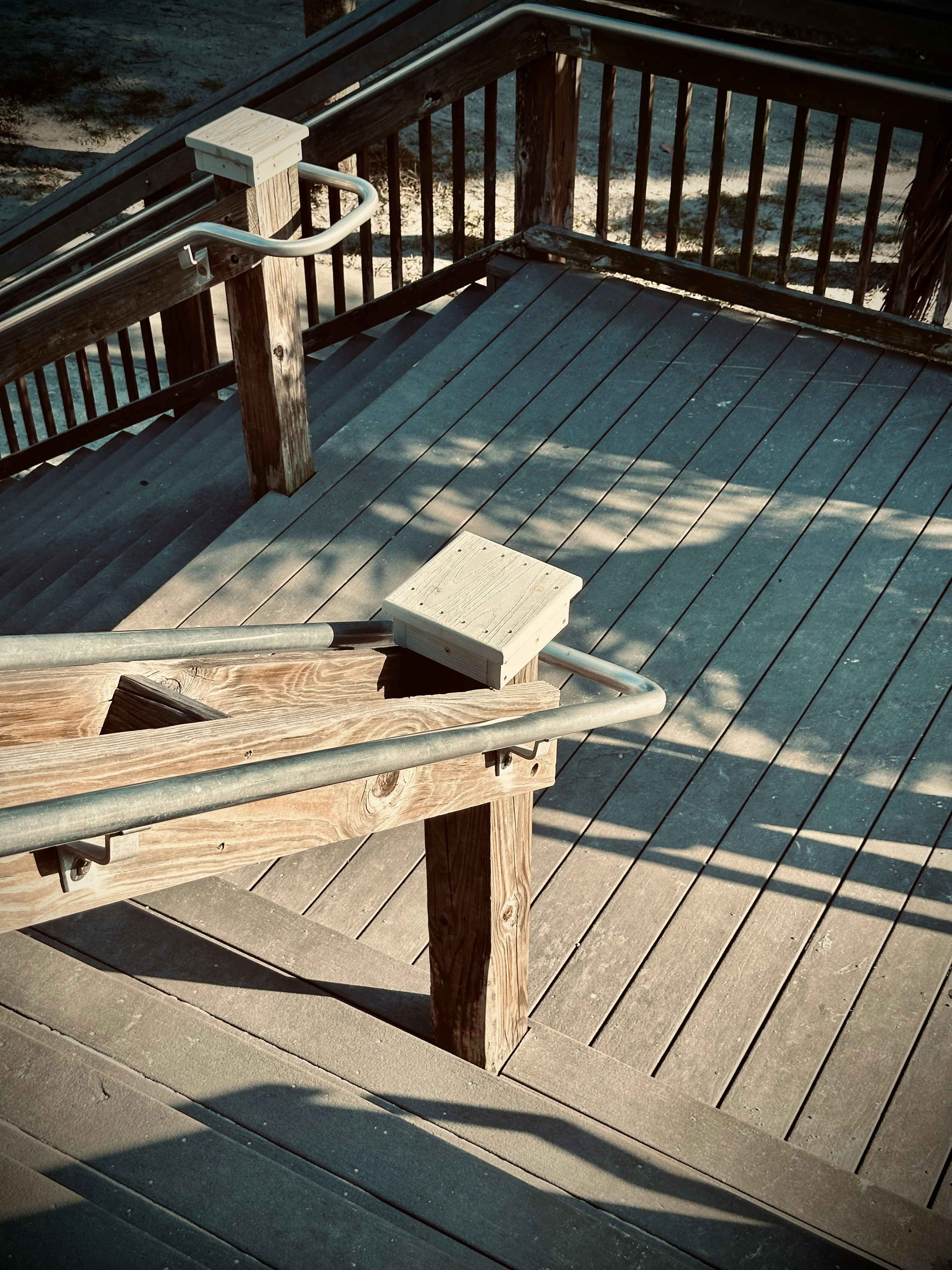 a wooden bench sitting on top of a wooden deck