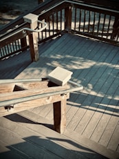 a wooden bench sitting on top of a wooden deck