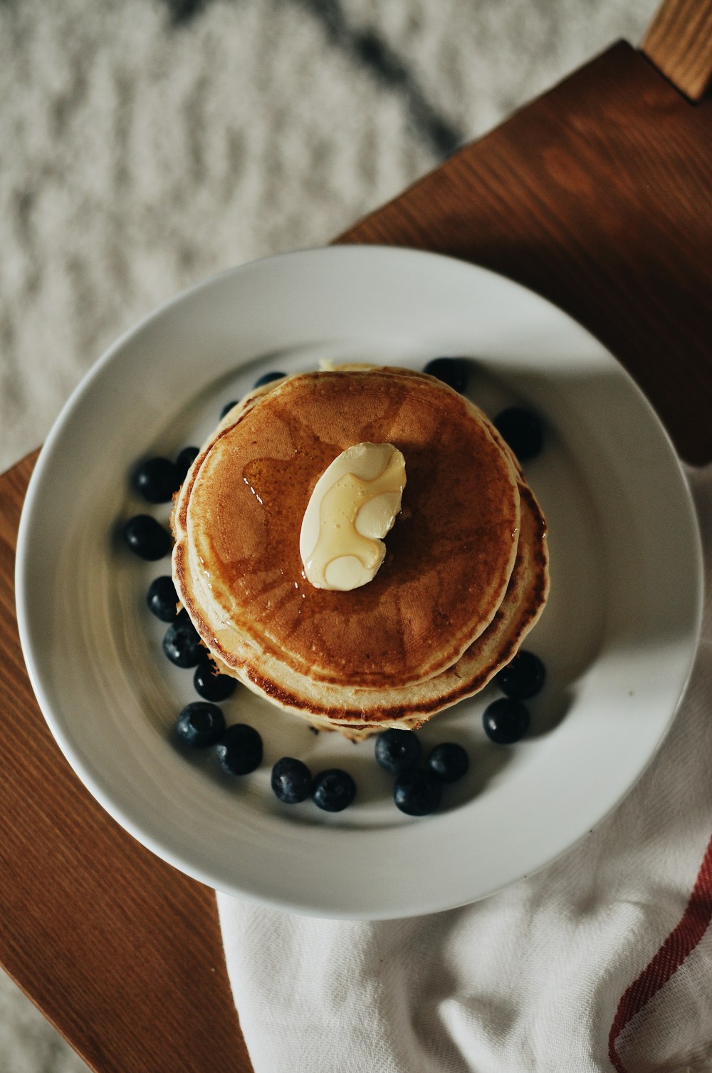 a white plate topped with pancakes and blueberries