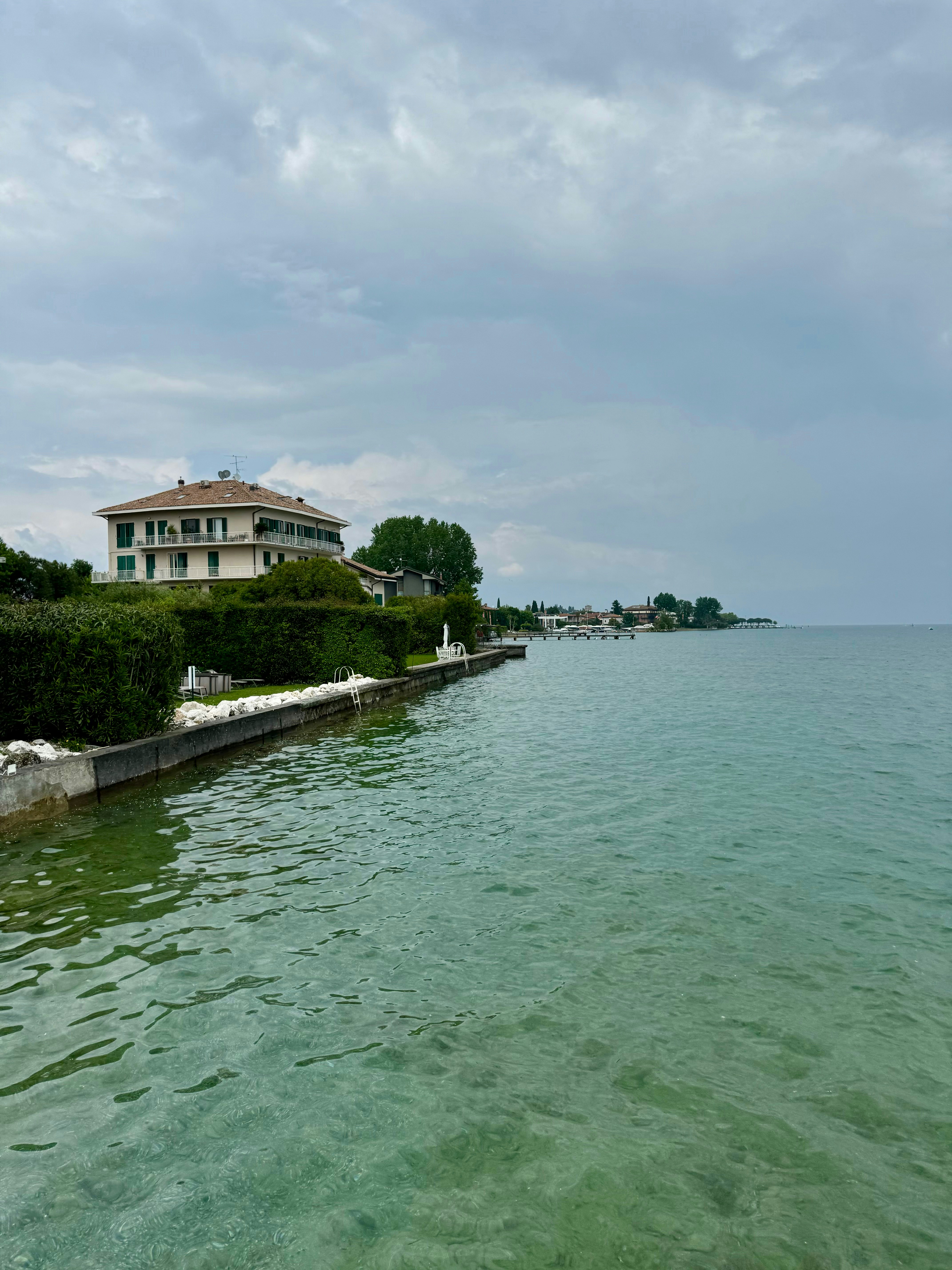 a large body of water with a house in the background