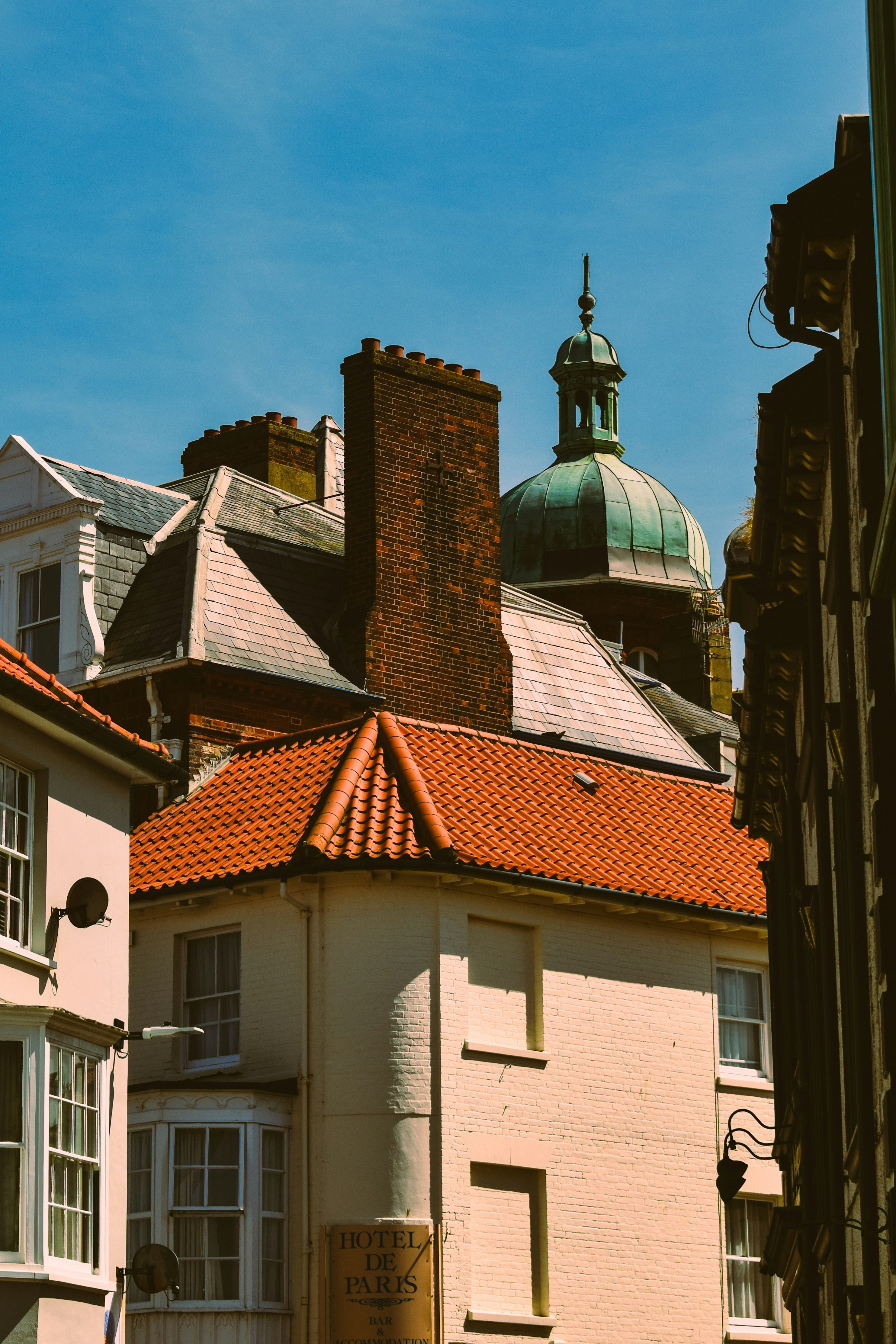 a white building with a red tiled roof