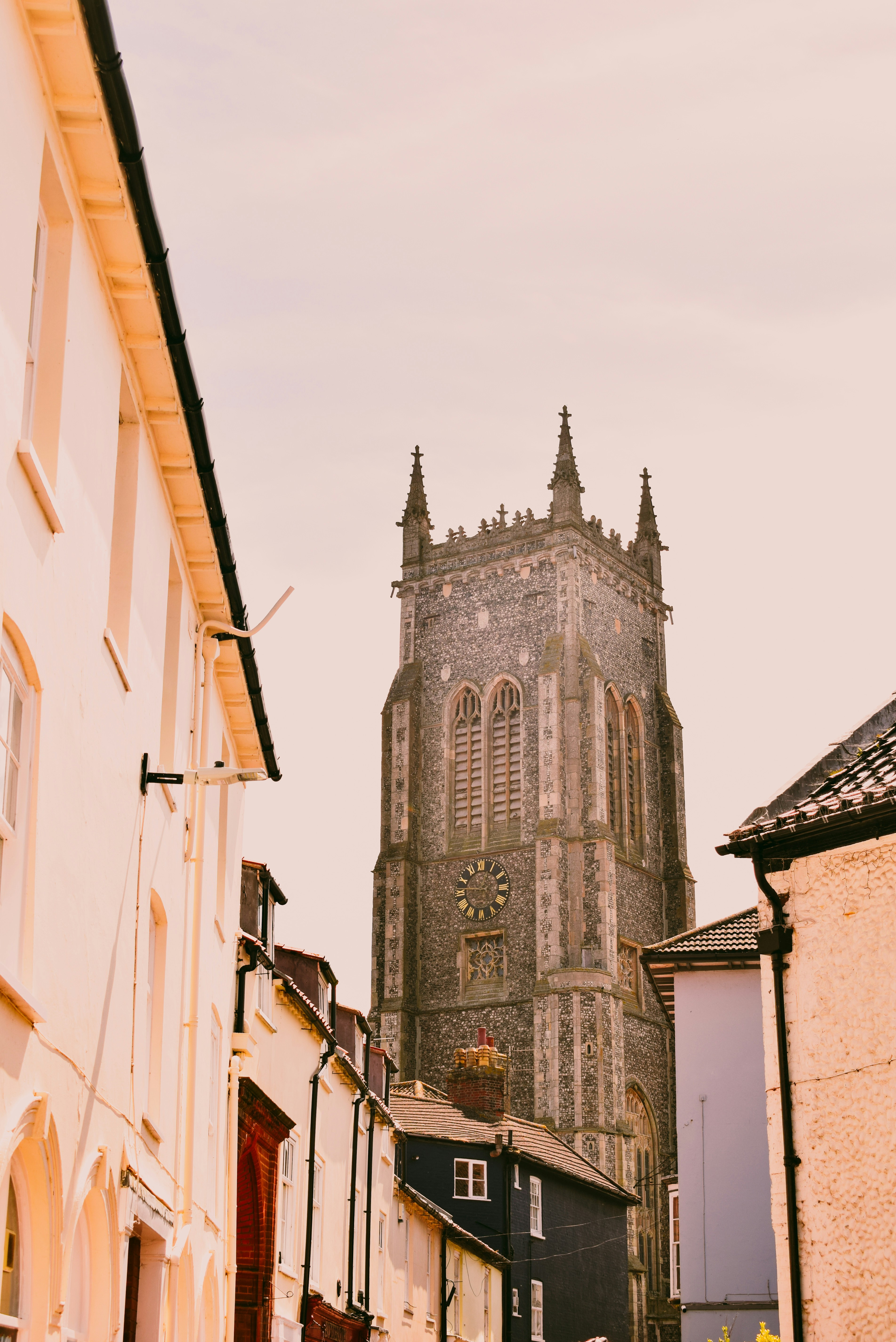 a tall church tower towering over a city