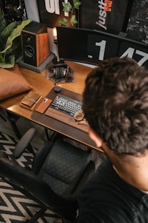 a man sitting at a desk with a keyboard and mouse