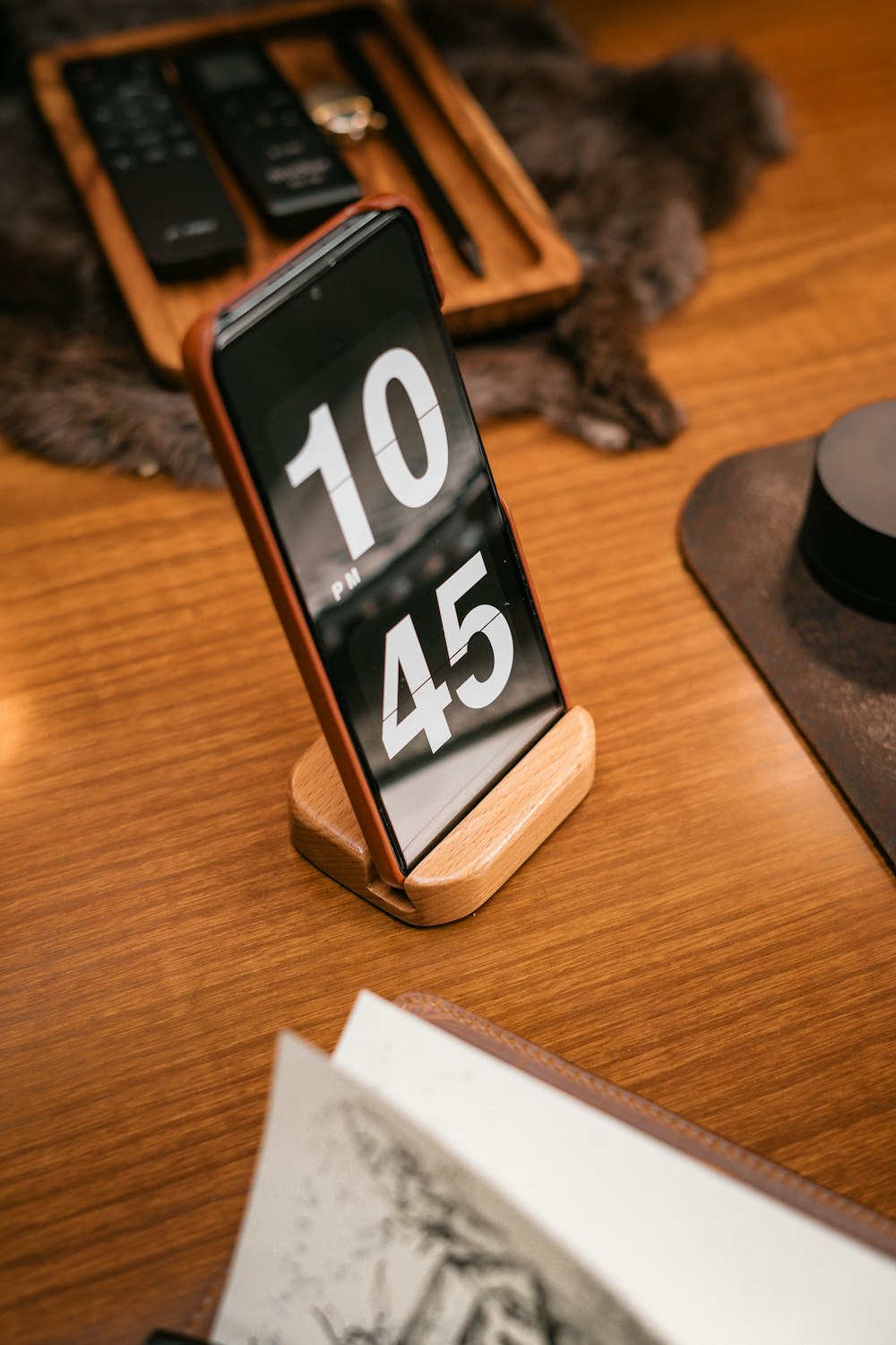 a cell phone sitting on top of a wooden table