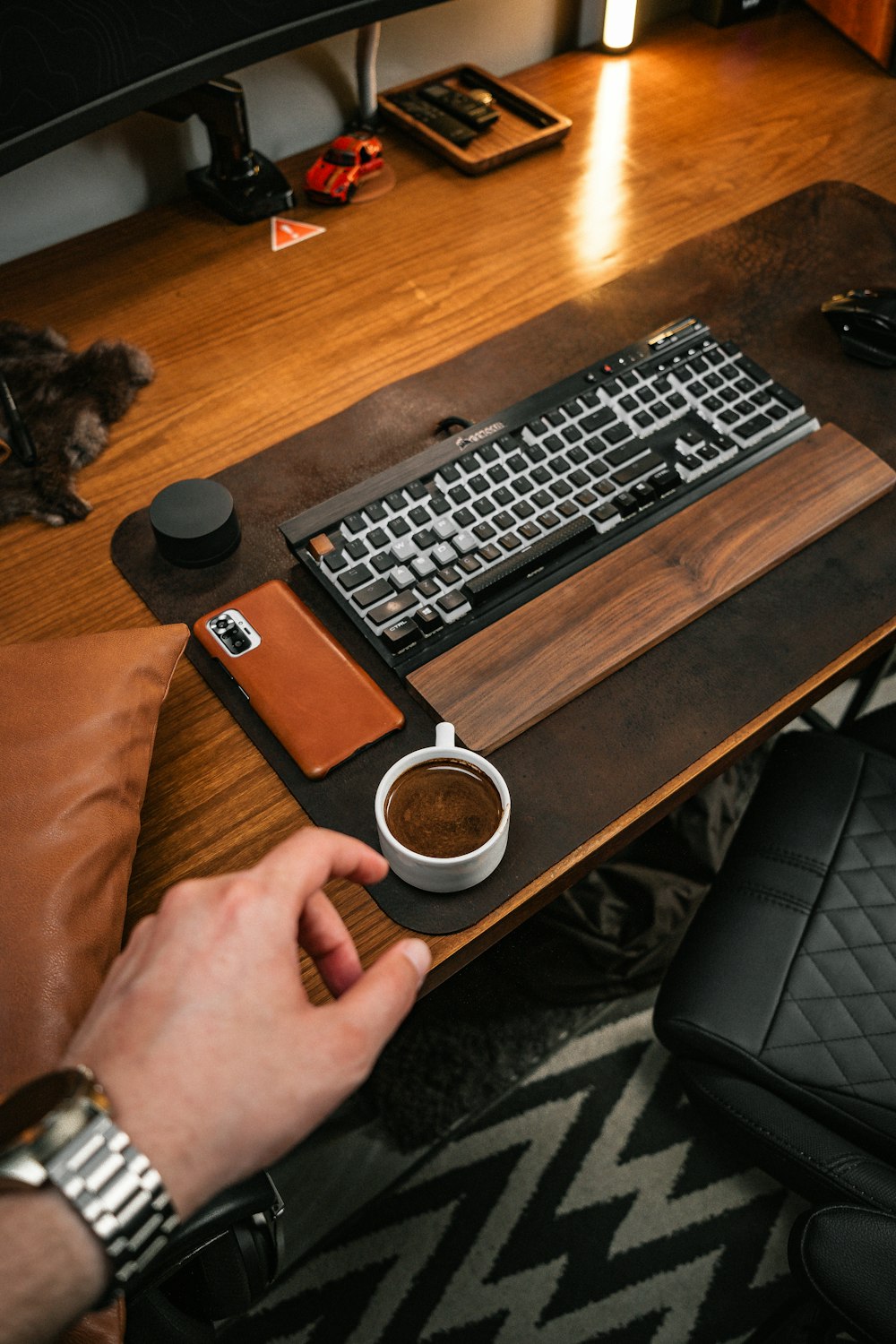 a person sitting at a desk with a keyboard and mouse