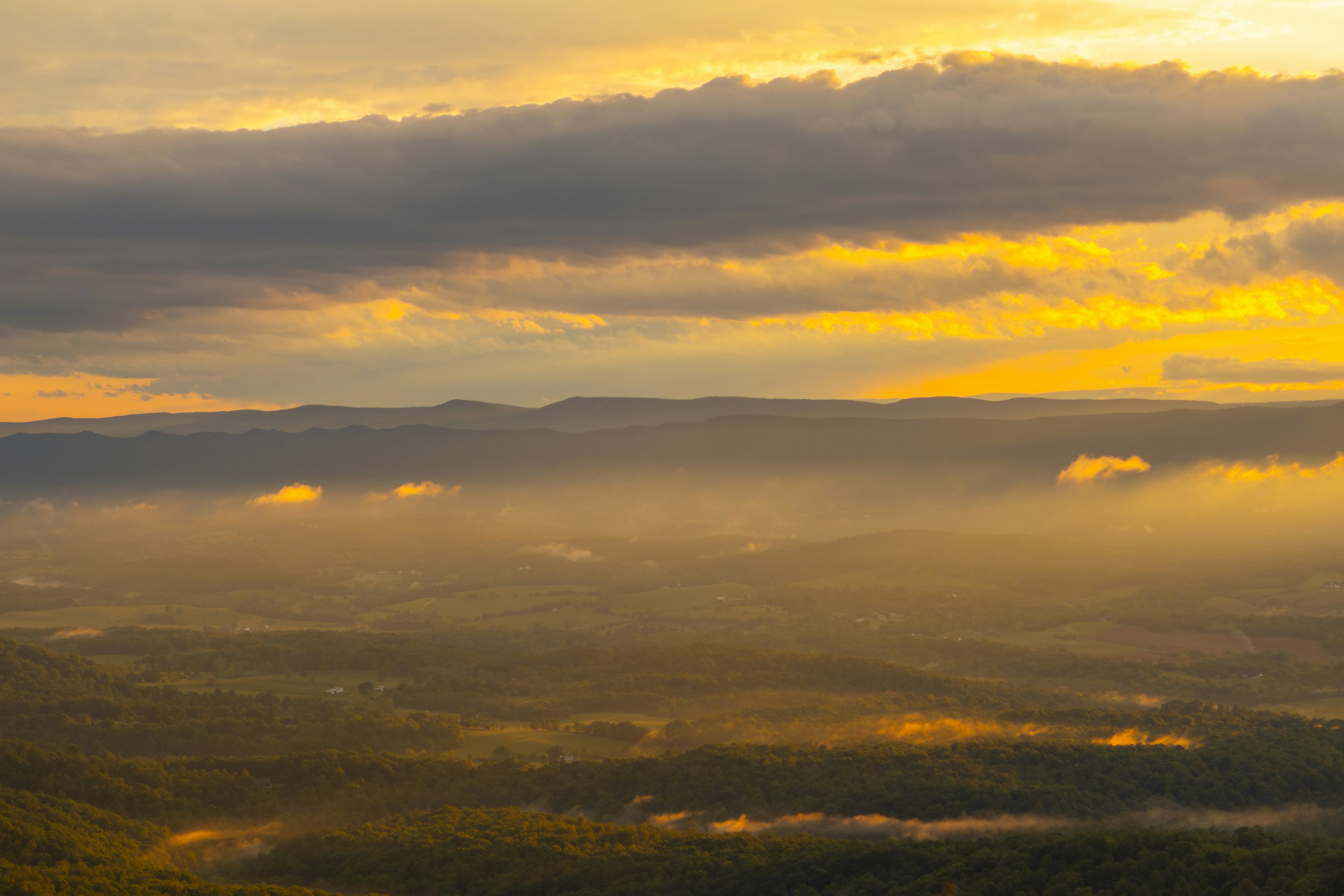 Ethiopian highland landscape panorama at sunrise, dramatic golden light, misty valleys, ancient mountains