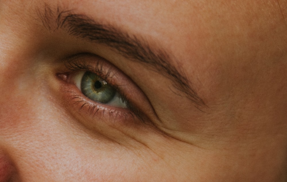 a close up of a person's green eyes