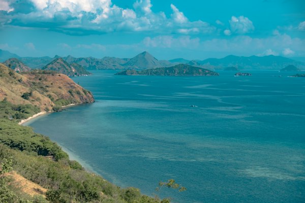 A large body of water surrounded by mountains — Komodo & Flores, Indonesia