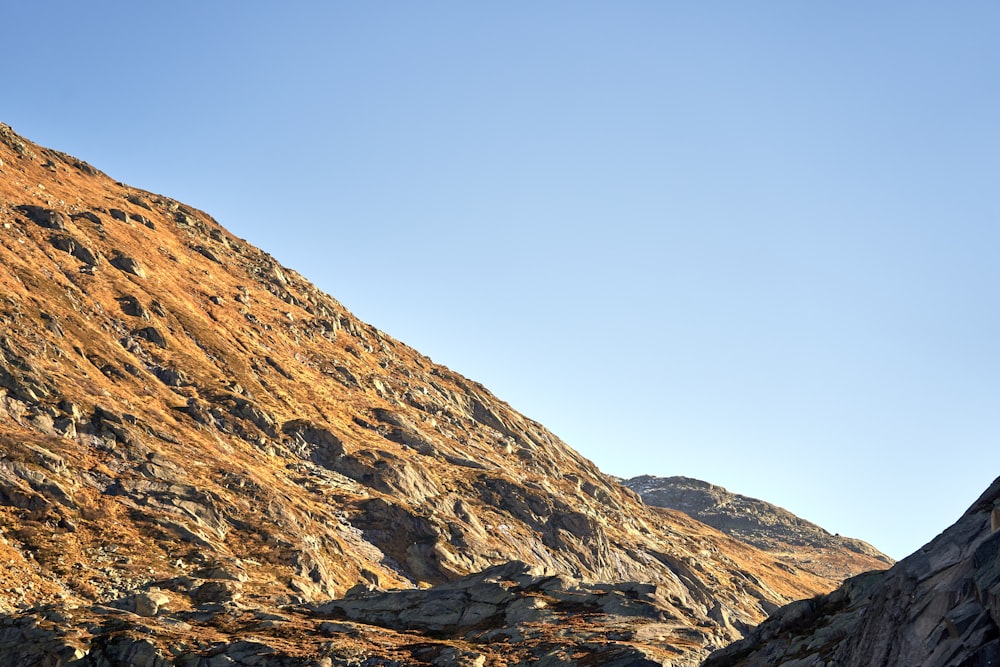 a view of a rocky mountain with a clear blue sky