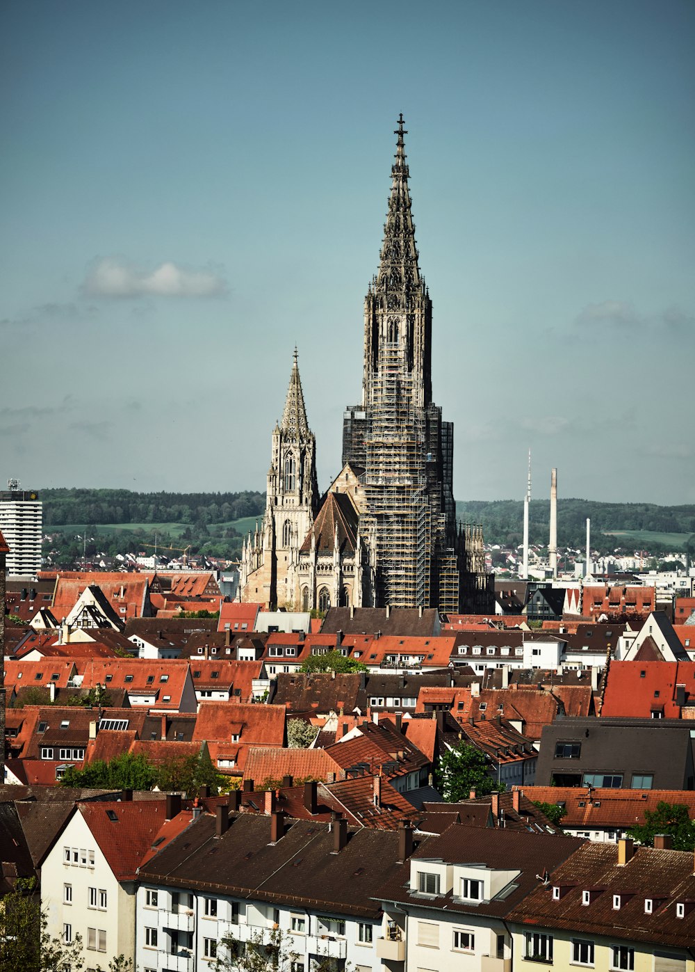 a large cathedral towering over a city filled with tall buildings