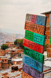a stack of colorful wooden signs sitting on top of a roof