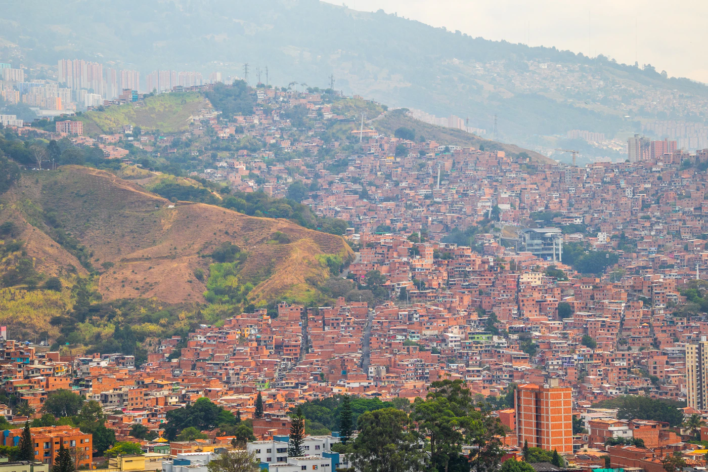Medellín Colombia cityscape with the city spread across the Aburra Valley with the hillside comunas rising on both sides and mountains visible in the background