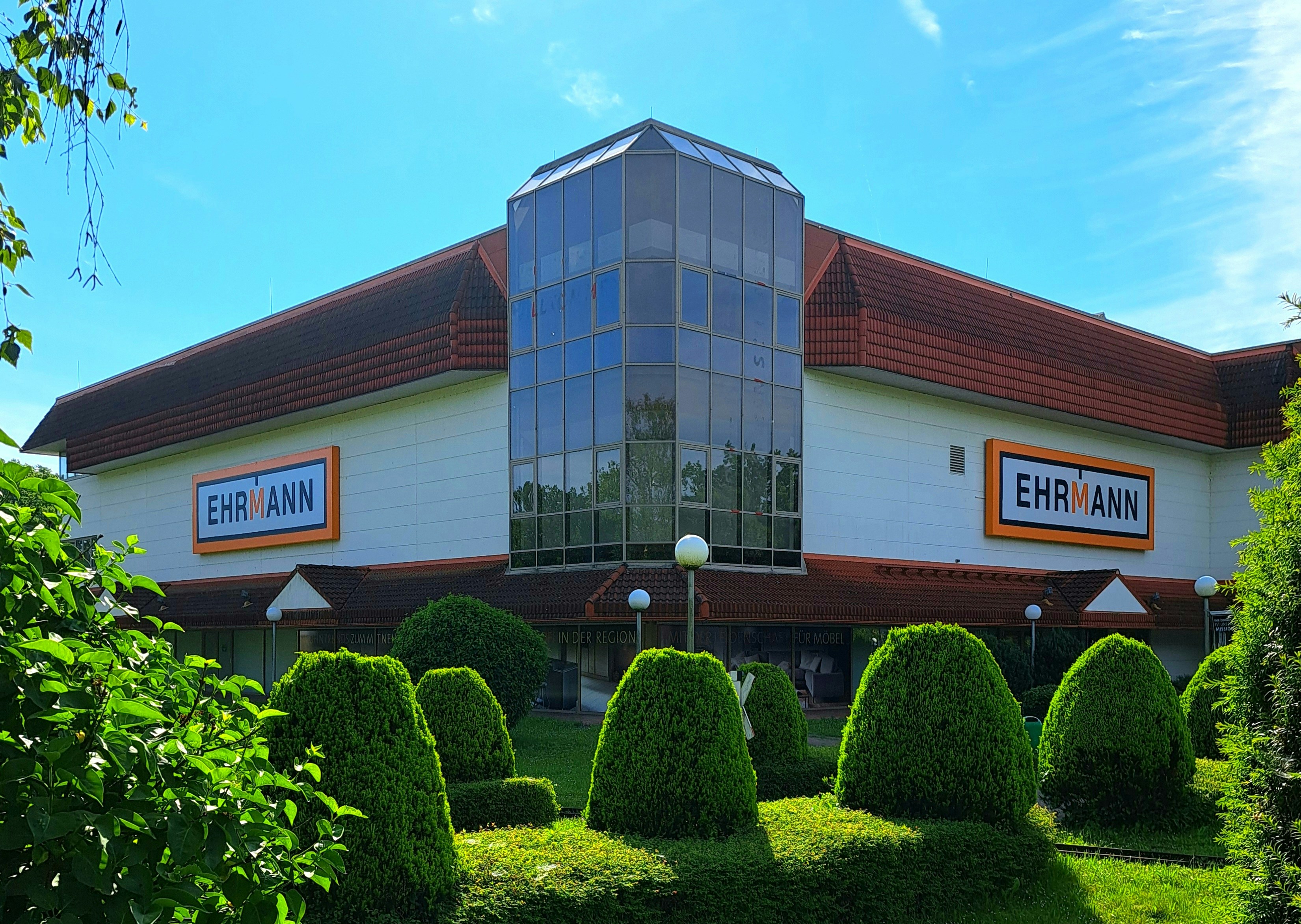 a building that has a lot of bushes in front of it