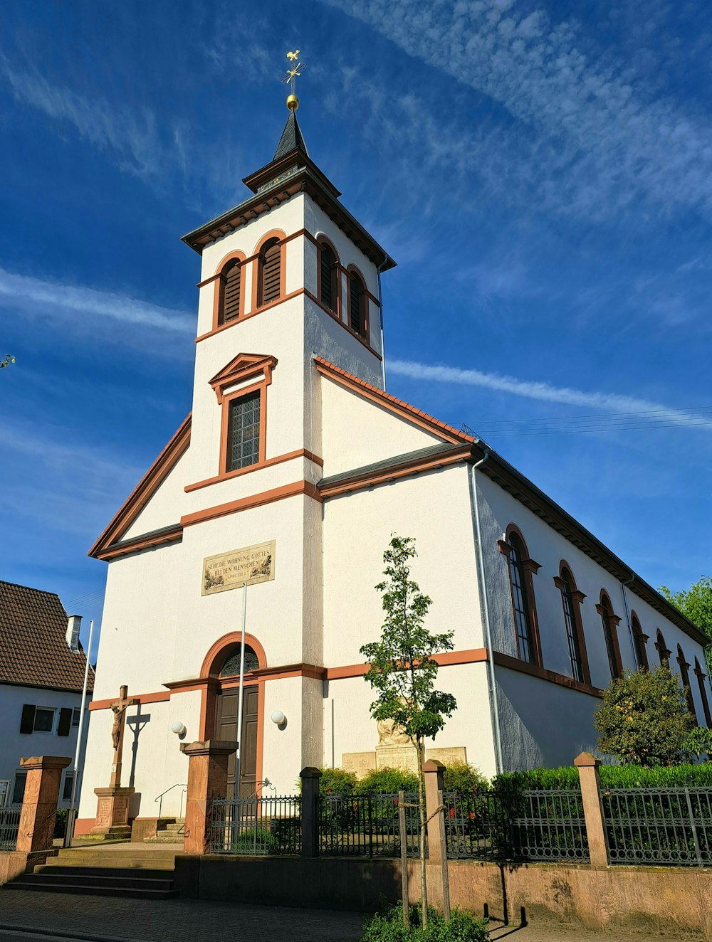 a church with a steeple on a sunny day