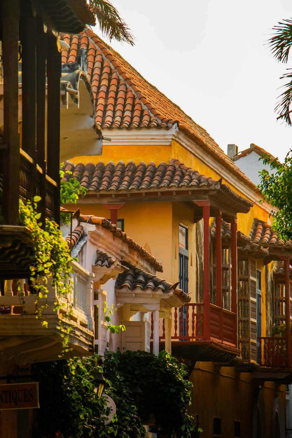 a yellow building with a red and white roof