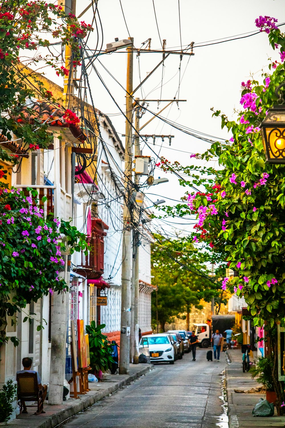 a city street with lots of power lines above it