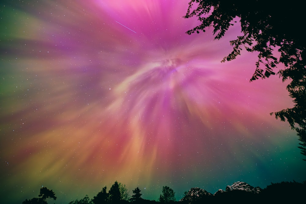 a colorful aurora bore is seen in the night sky
