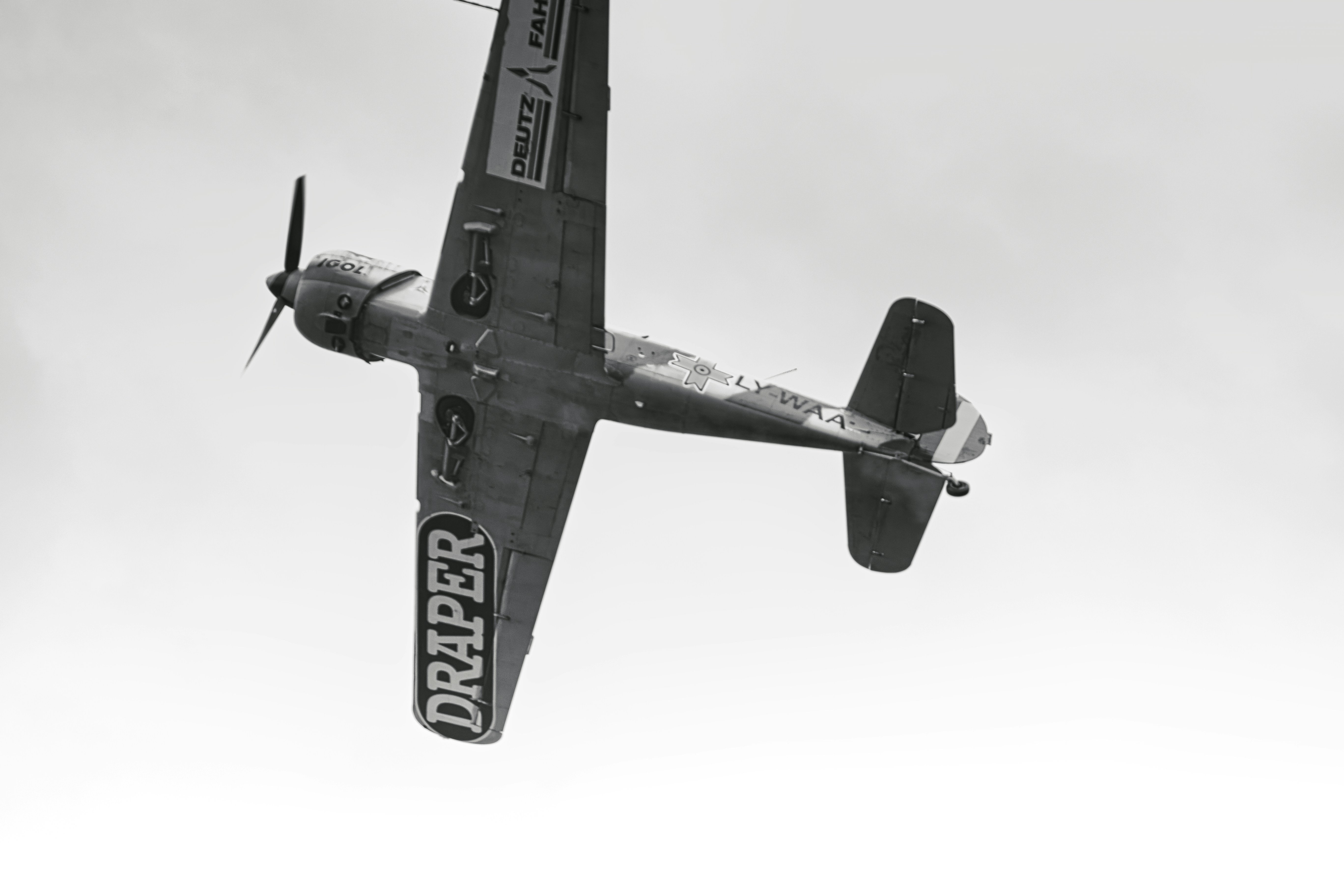 a black and white photo of a plane flying in the sky, Open Training Day – Iacari Acrobats, foray into the fascinating world of aerobatics, Banesti, Romania