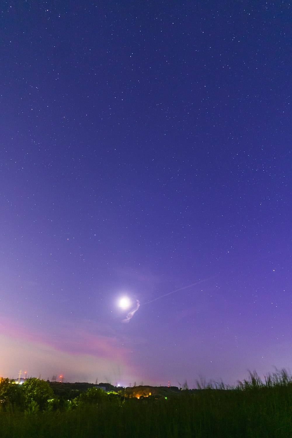 a view of the night sky with the moon in the distance