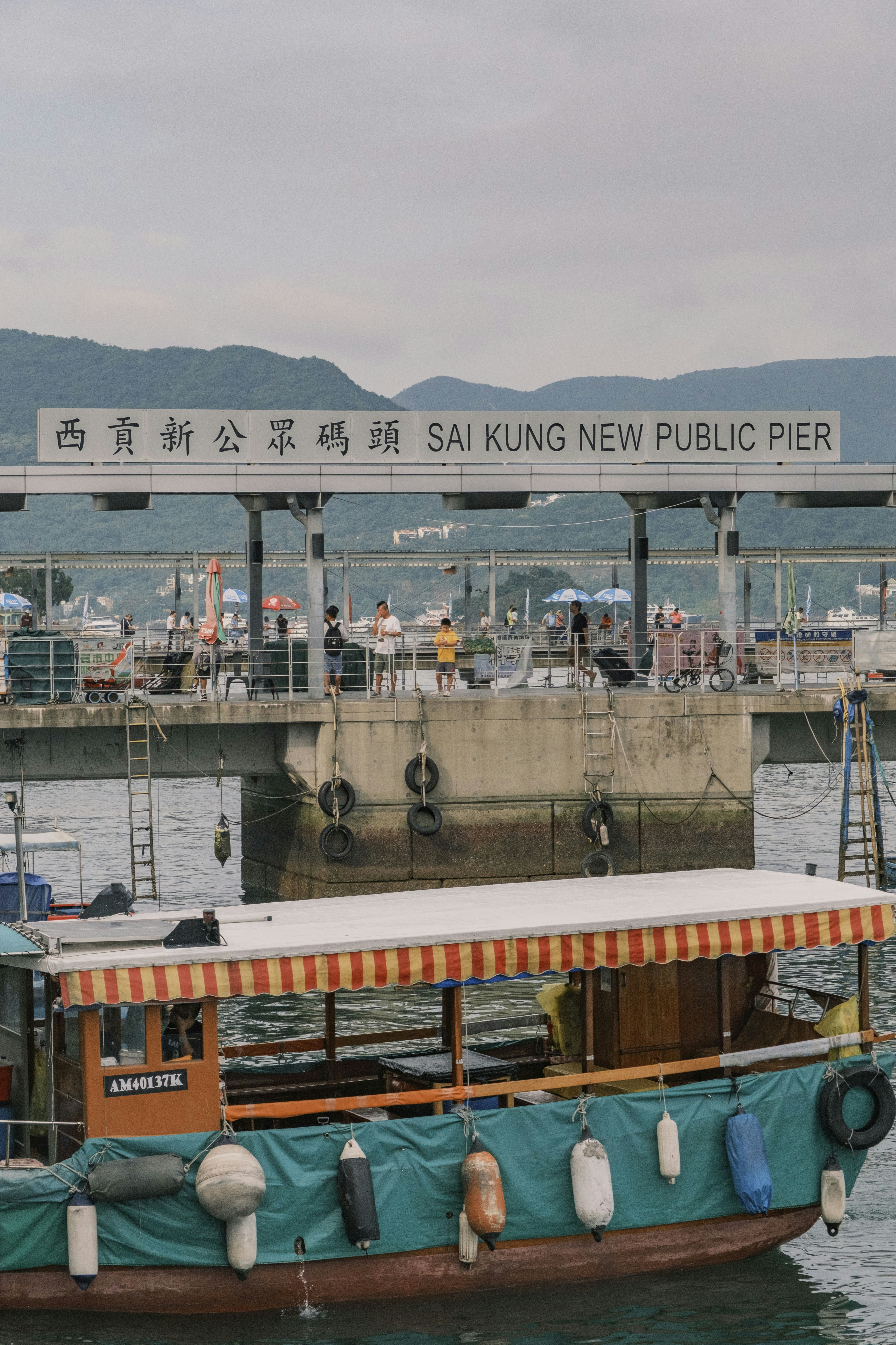 a boat is docked at a pier in the water