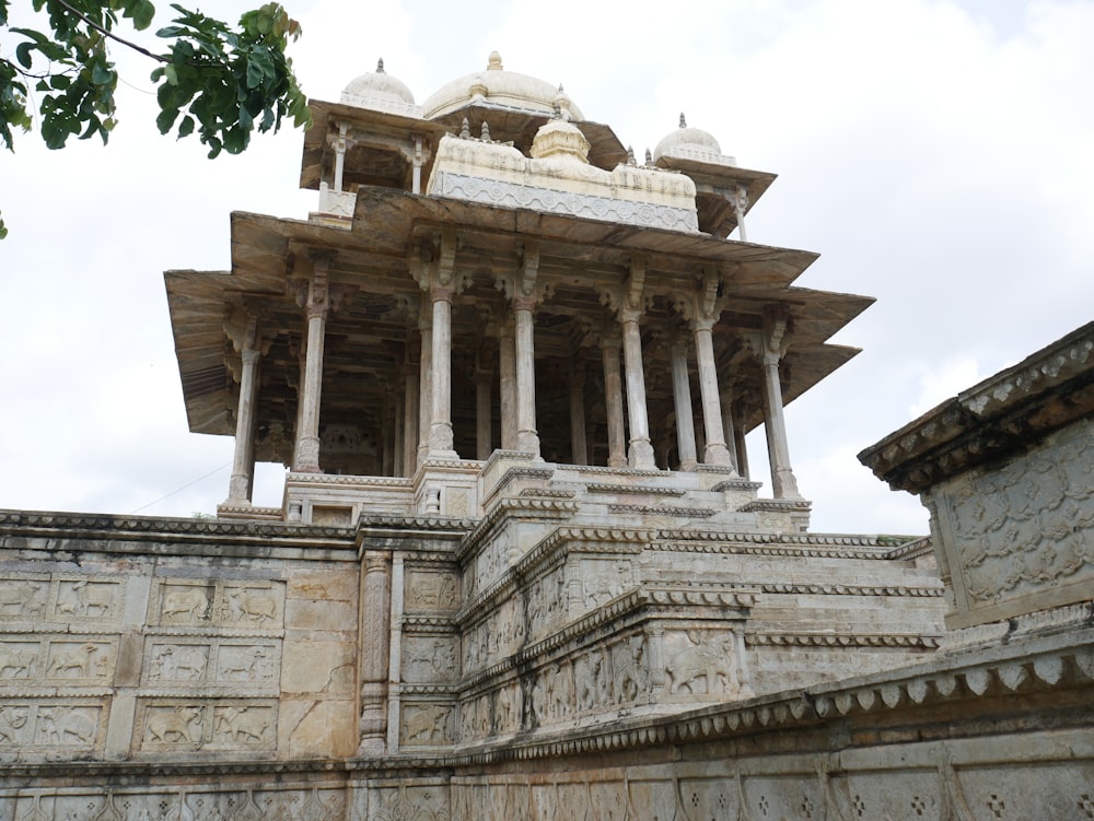 a large white building with pillars and a clock