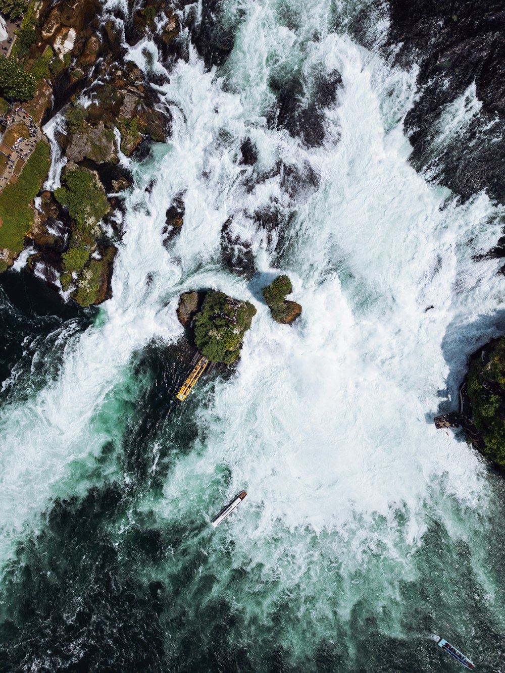 an aerial view of a body of water surrounded by rocks