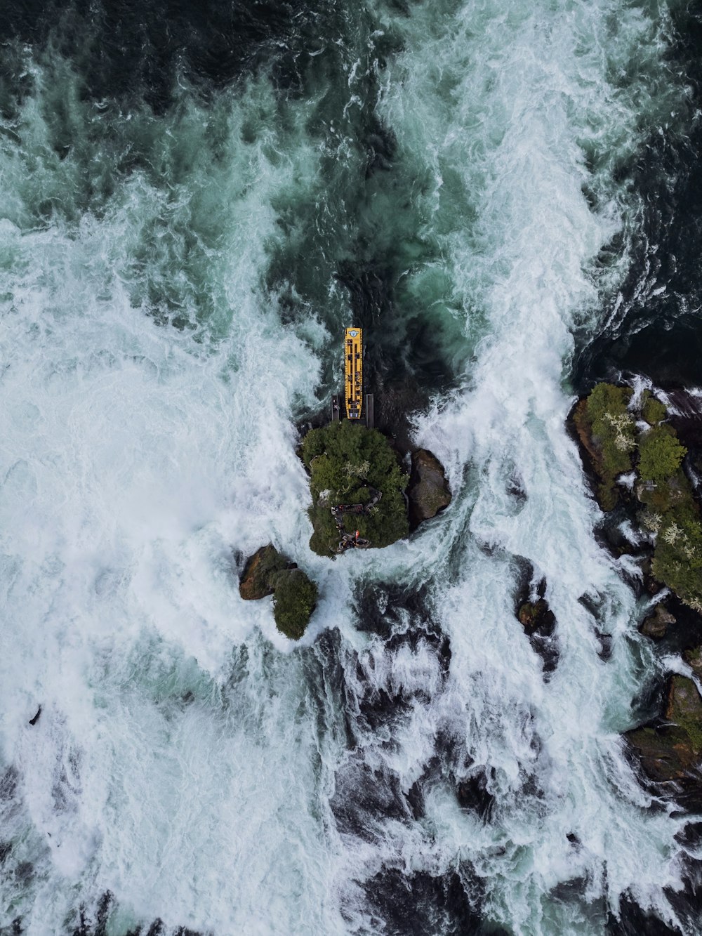 an aerial view of a boat in the ocean