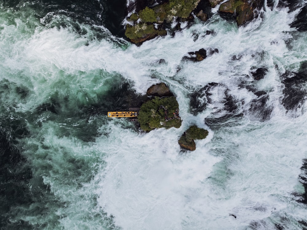 an aerial view of a body of water surrounded by rocks